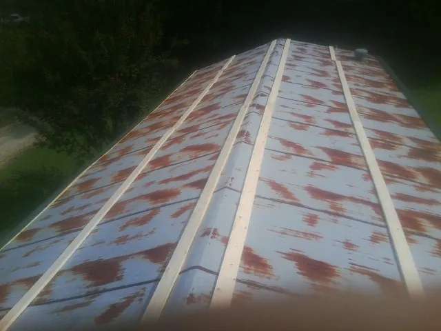 Rusted metal roof panels with new wood purlins before replacement — Storm Damage Roof Repair in Lake Charles by Roofing Brothers